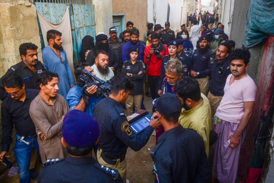 Police test the biometrics of Afghan refugees during a search operation on the outskirts of Karachi, Pakistan, on November 17, 2023.