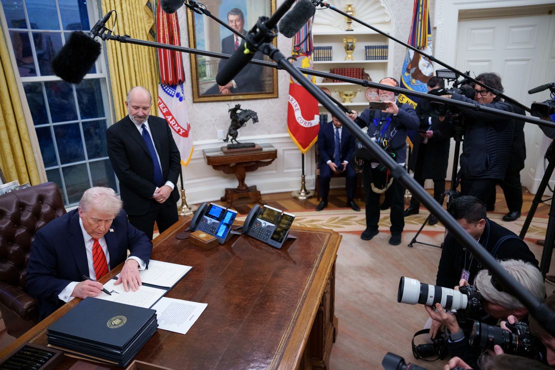 President Donald Trump — joined by Howard Lutnick, his nominee for Commerce secretary — signs a series of executive orders in the Oval Office in Washington, DC, on February 10.